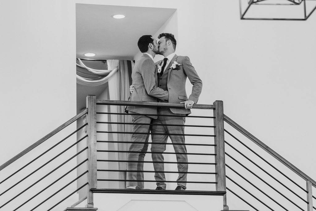 man and man kissing during their introductions at their LGBTQ wedding