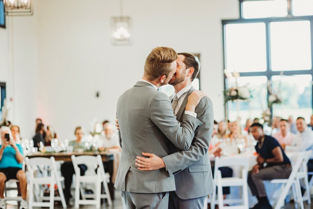 man and man kissing during their first dance at their LGBTQ wedding