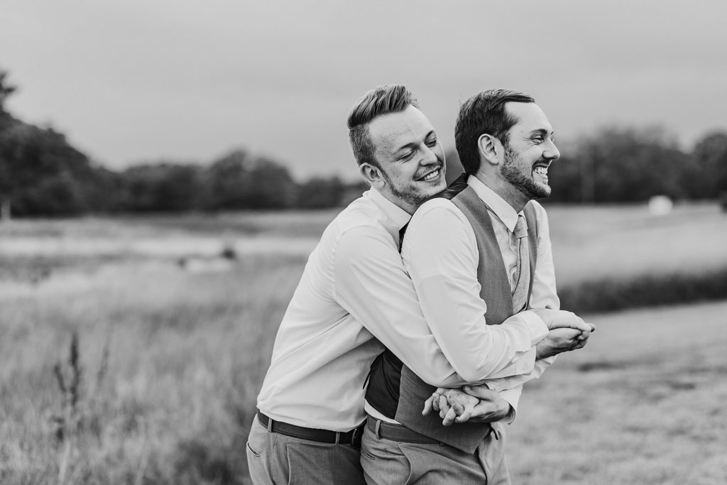 man and man snuggling each other at their LGBTQ wedding