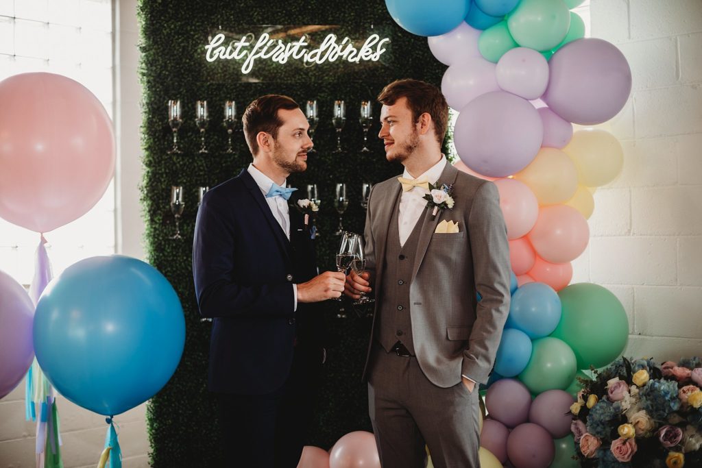 Two men sharing champagne at an Indianapolis Wedding Venue called the ivory foundry