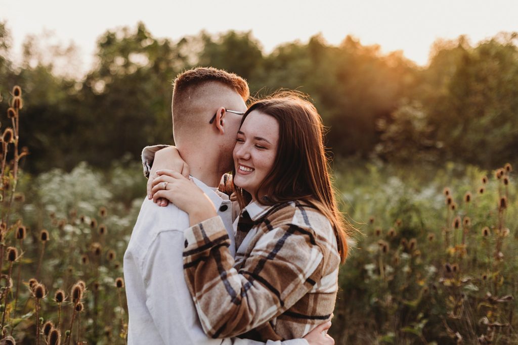 man and woman holding onto one another at their Fall Indiana Couples Session