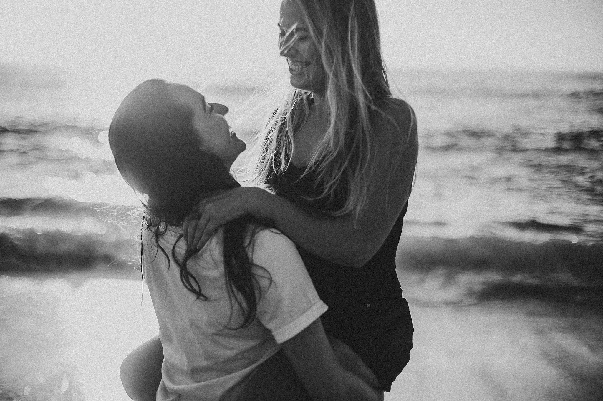two women holding onto one another at their La Jolla California Couples Session