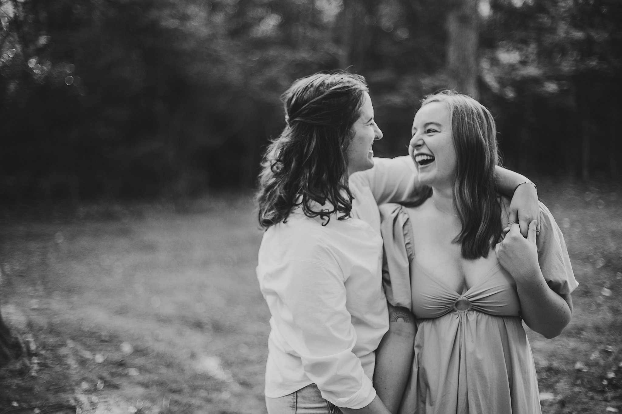 Samantha Mitchell, an LGBTQ Engagement photographer captures two women at Prophet's Rock in Indiana. The two women are snuggling together in a forest.