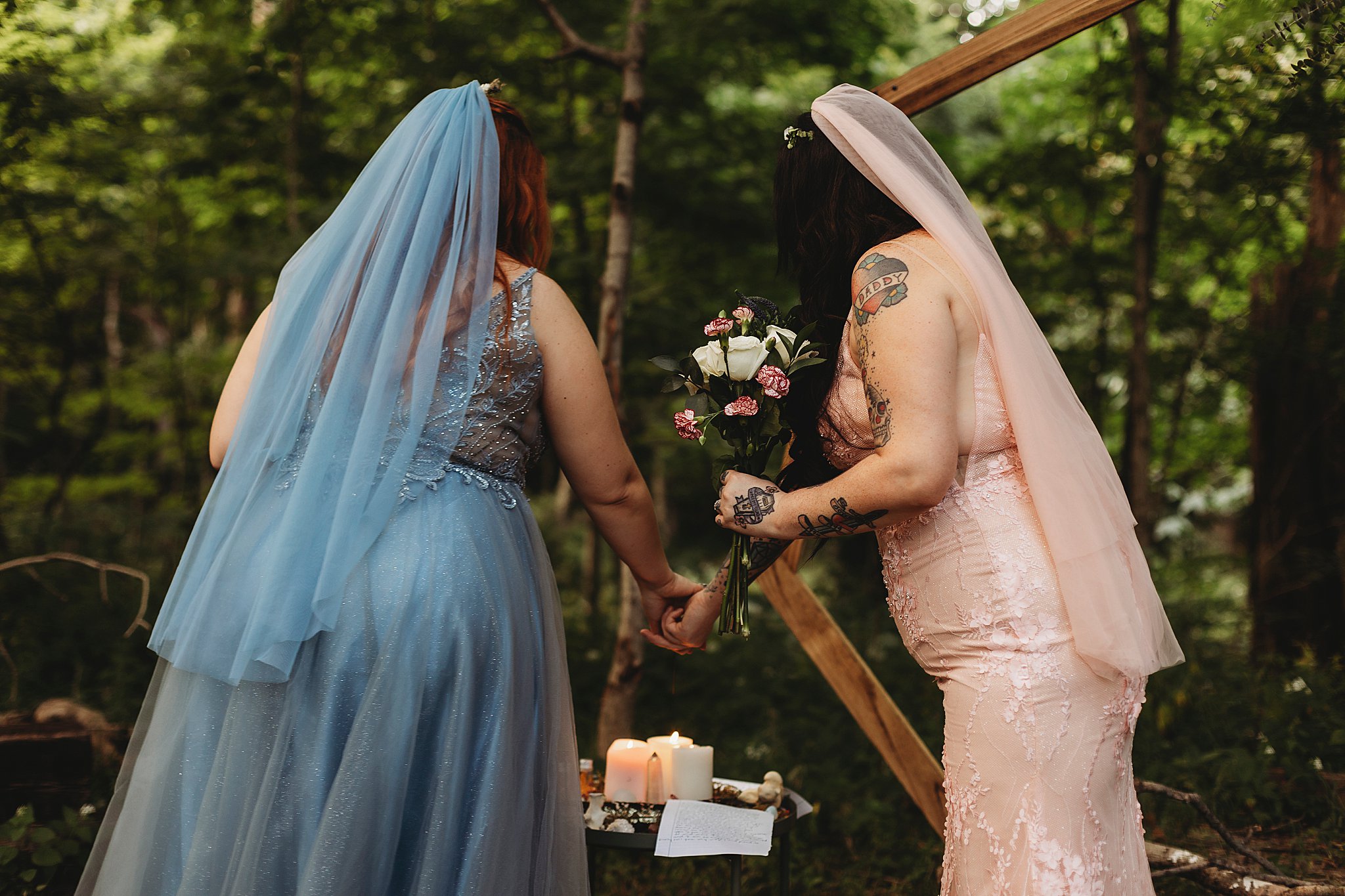 couple lighting their unity candles at their lgbtq elopement