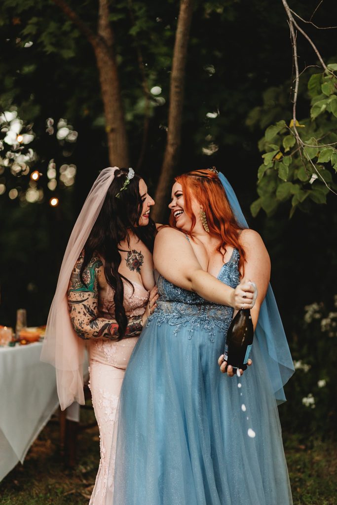 lgbtq couple popping champagne after their turkey run state park elopement