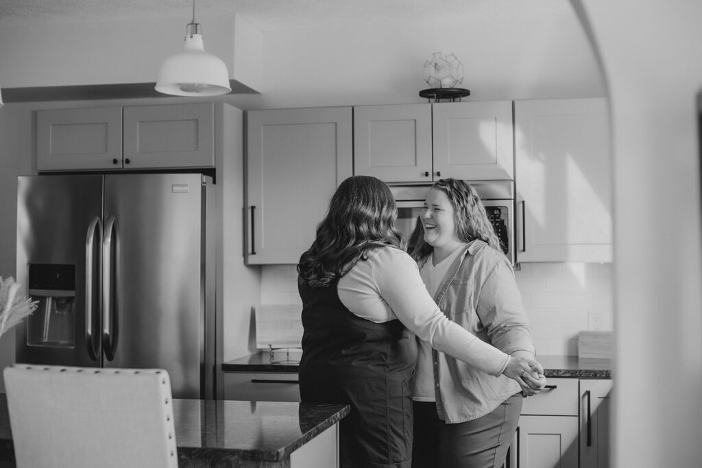 indianapolis indiana engagement photographer captures an lgbtq couple dancing in their kitchen at their engagement session in indianapolis, indiana 