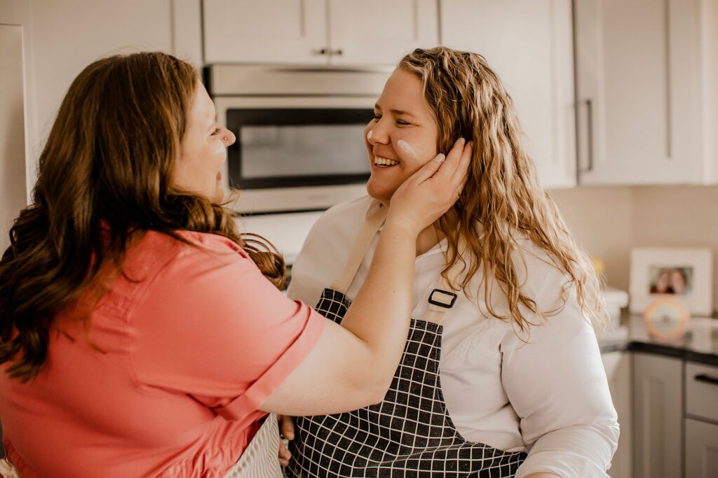 indianapolis indiana engagement photographer captures an lgbtq couple baking in their kitchen in indianapolis, indiana