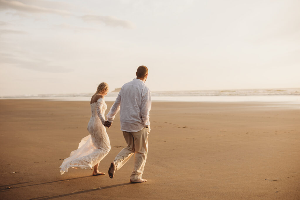 ultimate Oregon elopement guide couple holding hands as they run toward the oregon coast